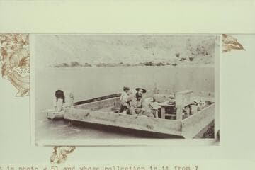 Arthur c.Waller sits in the scow near the desk. Lees Ferry. Copy of print in Waller collection