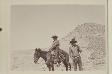 Buck Whitehat and Tobe Owl at upper end of the black brush mesa north of the northeast fork of 73l.6. Fifty Mile Mountain in distance