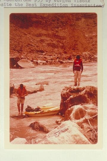 Dock Marston watches Buzz Belknap line rapid at Mile 204.55. Opposite the Best Expedition inscriptions