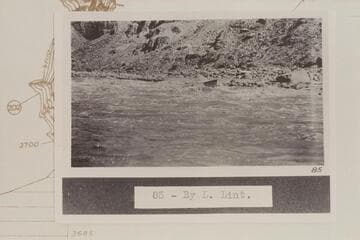 The flat-decked USGS skiff in Rapid No. 20. Rapid No. 20 heads at Mile 203.15 and drops 8 ft. in .15 miles. The boat is at the lower end of the island. Compare 64-3-31 CTCN 203-13
