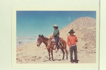 Buck Whitehat and Tobe Owl at upper end of the black brush mesa north of Lehi Canyon. Fifty Mile Mountain in the distance. Tobe Owl is the younger brother of Nasja Begay