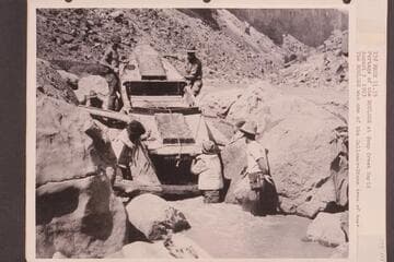 Portage of the "Boulder" at Soap Creek Rapid. The "Boulder" was one of the Galloway-Stone type of boat used by the USGS in their traverse of the Canyon to make the present-day profile maps