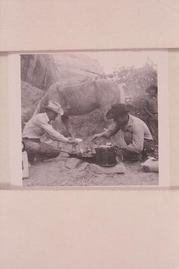 Tom Daly and Buster Ordiway create some pancakes for breakfast as Tobe Owl looks on; Middle Fork of 73