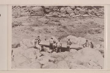 Portaging the "Coronado" at Vulcan Rapid. Adger wears the striped shirt. Bartl is at the bow