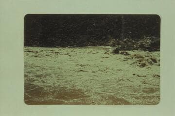The "Esmeralda" pushing out of the lower end of Badger Rapid. Ed Hudson is at the wheel, Marston is piloting and Taylor rides as passenger