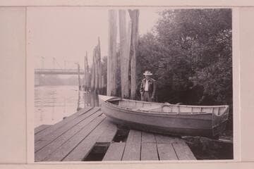The "Julius" (Holmstrom's boat) at Coquille, Oregon. Mrs. Holmstrom sold the boat and the stern has been cut off and the decks removed to use for fishing with outboard motor. The present owner is behind the skiff